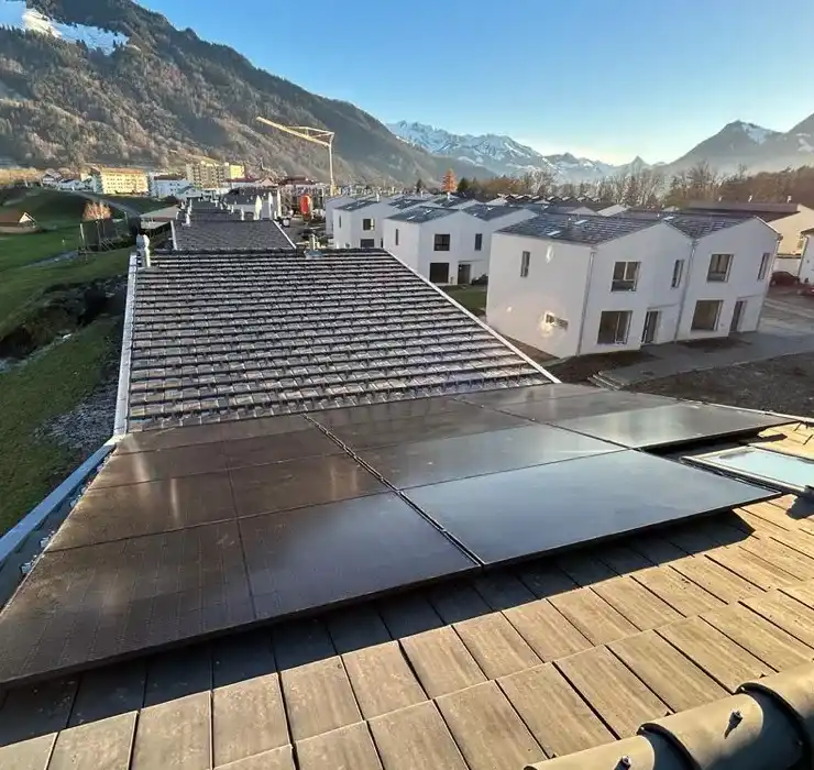 Installation solaire photovoltaïque sur un ensemble de maisons résidentielles à Broc, offrant une solution énergétique durable dans un cadre naturel.